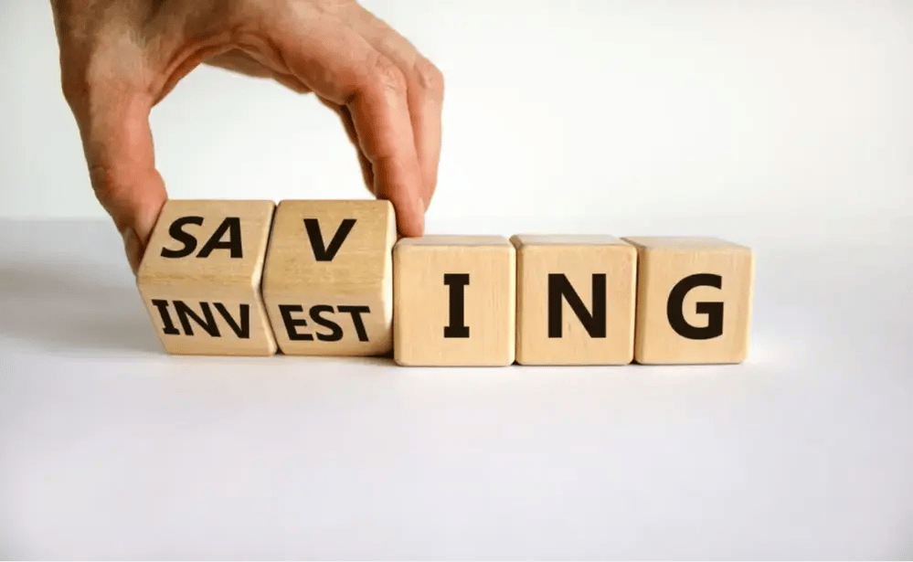 Person turns cubes and changes the word "investing" into "saving"